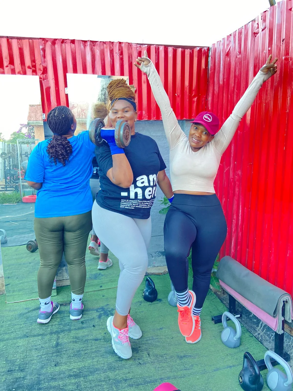Personal trainer providing hands-on coaching during a strength training session
